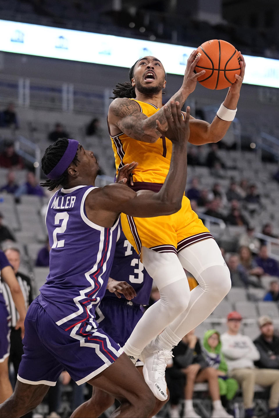 Arizona State guard Frankie Collins (1) leaps to shoot as TCU forward Emanuel Miller (2) defends during the second half of an NCAA college basketball game in Fort Worth, Texas, Saturday, Dec. 16, 2023. (AP Photo/Tony Gutierrez)