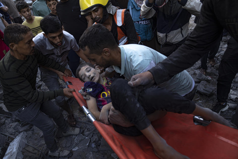 Palestinians evacuate wounded from a building destroyed in Israeli bombardment in Khan Younis, Gaza Strip, Thursday, Oct. 19, 2023. (AP Photo/Fatima Shbair)