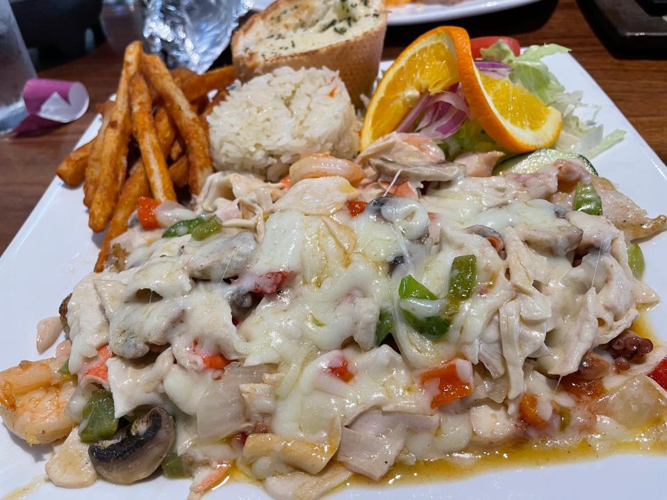 The Filete Rey at Mariscos Pacifico Nayarit is smothered with generous amounts of white fish, shrimp, octopus and other briny goodies. It was served with warm, buttered bread, seasoned French fries and white rice.