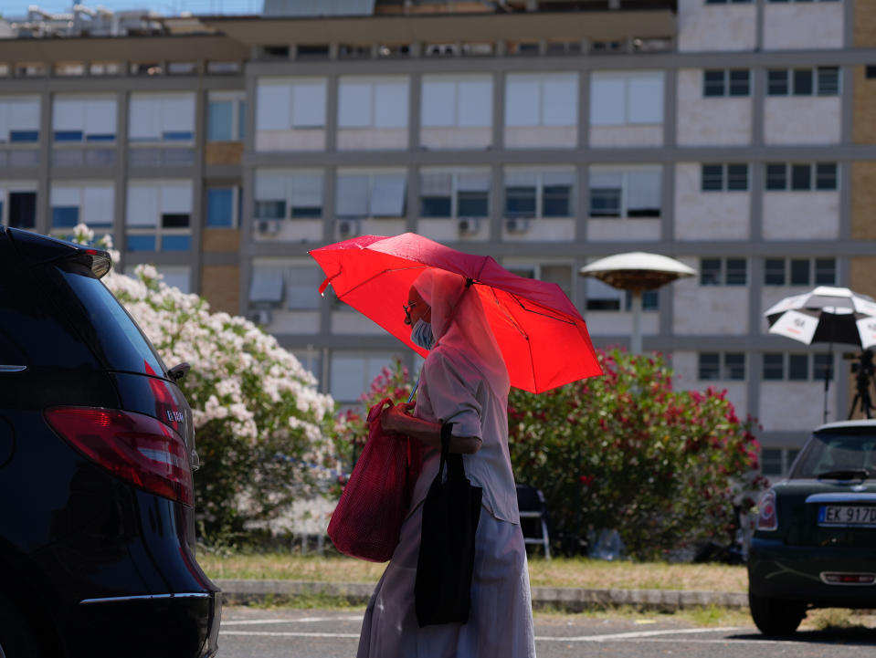 A nun walks outside the Agostino Gemelli Polyclinic in Rome, Tuesday, July 6, 2021, where Pope Francis was hospitalized Sunday. Pope Francis ate breakfast Tuesday, read the newspapers and took a walk as he continued recovering from intestinal surgery, the Vatican said, declaring his post-operative checks to be "good" and normal. (AP Photo/Domenico Stinellis)