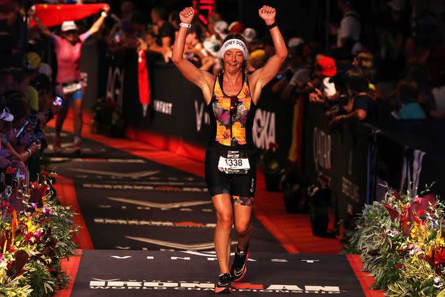 <p>Courtesy Hilary Baude</p> Hilary Baude crosses the finish line at the Iron Man World Championships.
