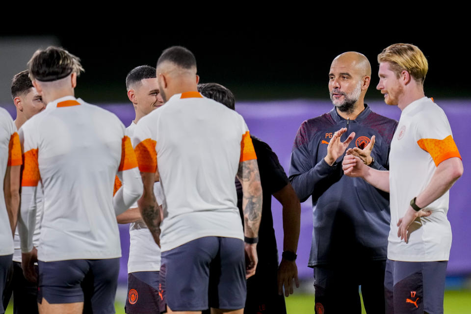 Manchester City's head coach Pep Guardiola, second right, applauds next to his players during a training session at the King Abdullah Sports City Stadium in Jeddah, Saudi Arabia, Monday, Dec. 18, 2023. Urawa Reds will play against Manchester City during the semifinal soccer match during the Club World Cup on Tuesday Dec. 19.(AP Photo/Manu Fernandez)