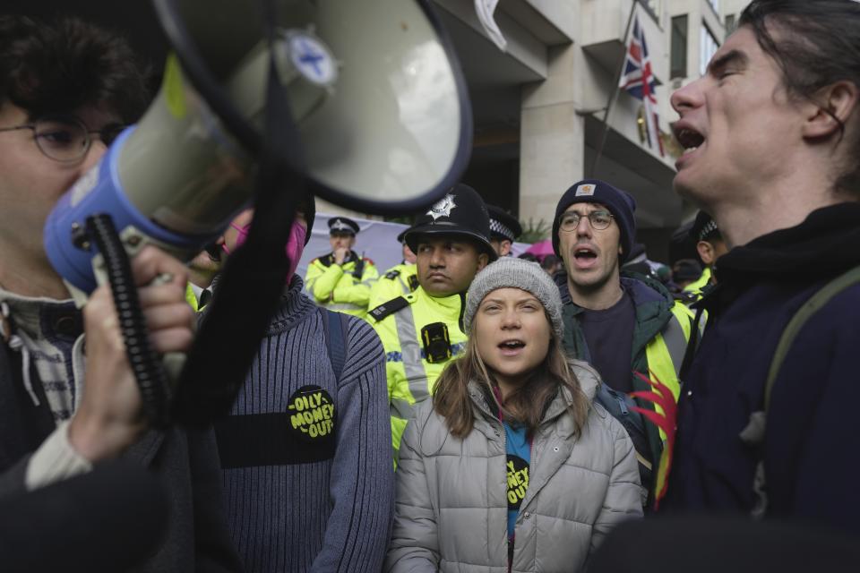 Environmental activist Greta Thunberg shouts slogans during the Oily Money Out protest outside the Intercontinental Hotel, in London, Tuesday, Oct. 17, 2023. (AP Photo/Kin Cheung)