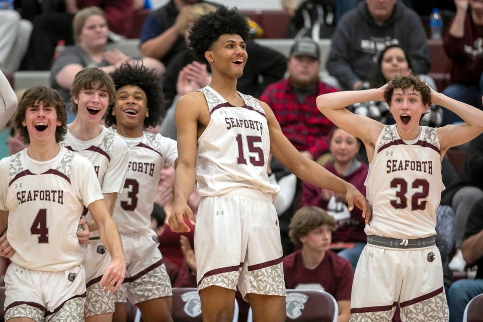 Seaforth High School’s Cooper Jones (4), Declan Lindquist (23), Noah Lewis (3), Jarin Stevenson (15) and Brandon Sturdivant (32) react after a basket by a reserve player in the closing minutes of their 75-48 victory over Graham High School on January 13, 2023 in Pittsboro, N.C.