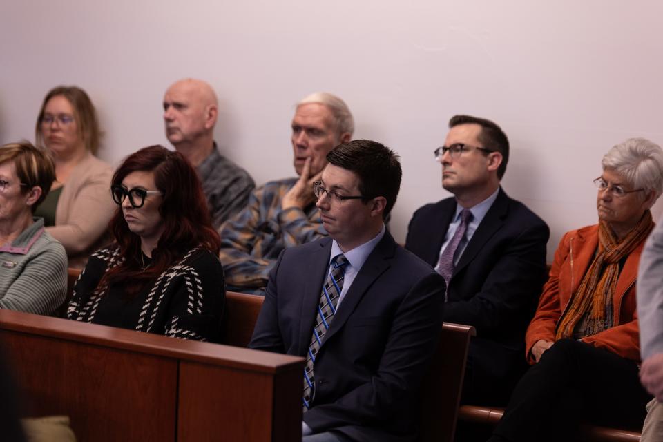 Ottawa County Clerk Justin Roebuck, right, and Board Chair Joe Moss, second from right, attend an evidentiary hearing Friday, Jan. 19, 2024, in Muskegon County's 14th Circuit Court.