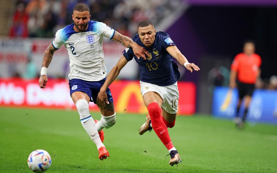 Kyle Walker of England vies with Kylian Mbappe of France during the FIFA World Cup Qatar 2022 quarter final match between England and France at Al Bayt Stadium on December 10, - Stefan Matzke/Getty Images