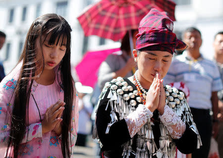 People attend a Mass celebrated by Pope Francis outside St Mary's Cathedral in Yangon, Myanmar November 30, 2017. REUTERS/Jorge Silva