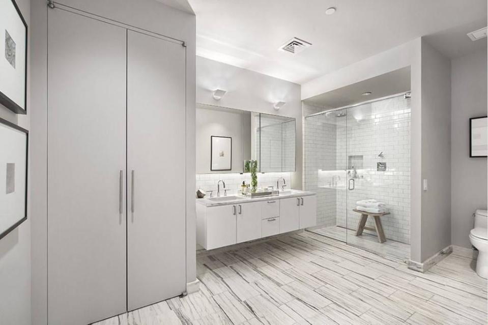 <p>The luxurious bathroom has his and hers sinks, a shower/steam room and marble flooring.</p>