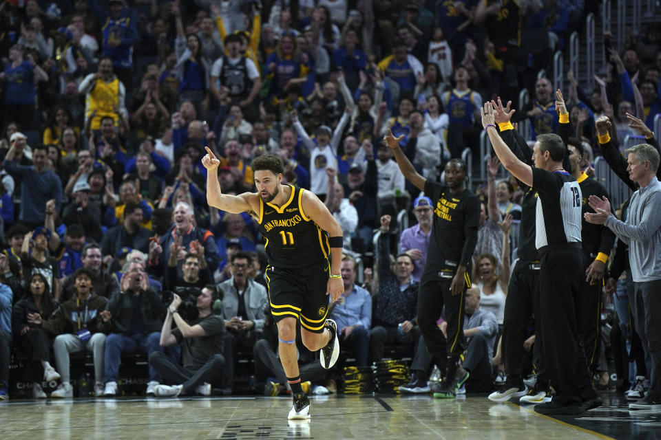 Golden State Warriors guard Klay Thompson (11) celebrates after making a three-pointer against the Cleveland Cavaliers during the first half of an NBA basketball game Saturday, Nov. 11, 2023, in San Francisco. (AP Photo/Loren Elliott)