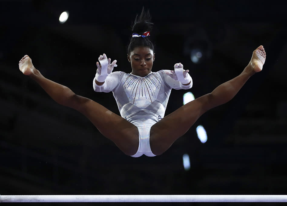 <p>Simone Biles performs on the uneven bars in the women’s all-around final at the Gymnastics World Championships in Stuttgart, Germany, on Oct. 10, 2019.</p>