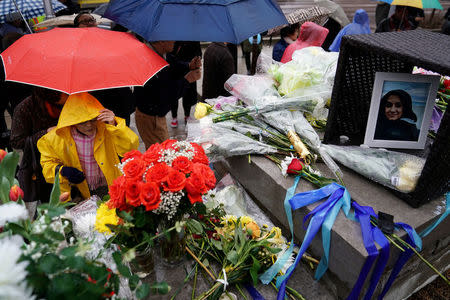 People pay their respects at a makeshift memorial on Yonge Street following a van that attacked multiple people in Toronto, Ontario, Canada, April 25, 2018. REUTERS/Carlo Allegri