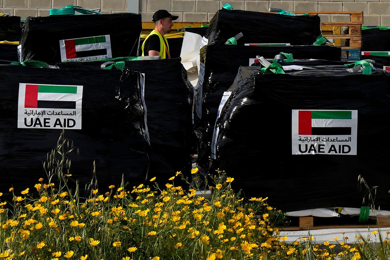 A member of the World Central Kitchen walks by humanitarian aid being loaded for transport to the port of Larnaca, Cyprus, for shipment to Gaza on March 13, 2024.