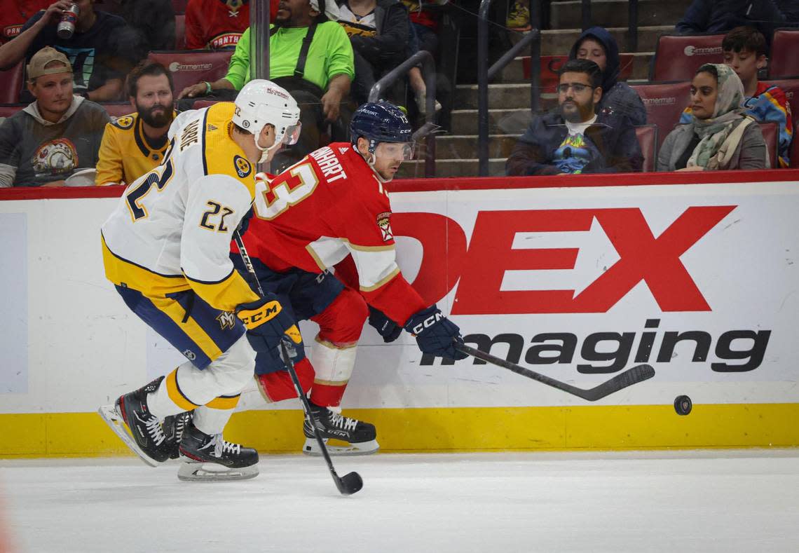 Florida Panthers center Sam Reinhart (13) keeps the puck from Nashville Predators defenseman Tyson Barrie (22) during the first period of a NHL game between the Florida Panthers and the Nashville Predators on Thursday, March 2, 2023, at FLA Live Arena in Sunrise, Fla. The Predators were up 2-0 at the end of the first period.