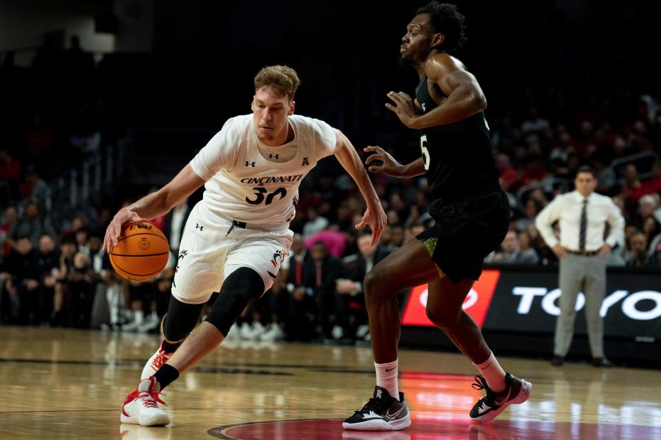 Cincinnati Bearcats forward Viktor Lakhin (30) drives on Cleveland State Vikings forward Deante Johnson (35) in the first half of the men’s NCAA basketball game between the Cincinnati Bearcats and the Cleveland State Vikings at Fifth Third Arena in Cincinnati on Thursday, Nov. 10, 2022. 