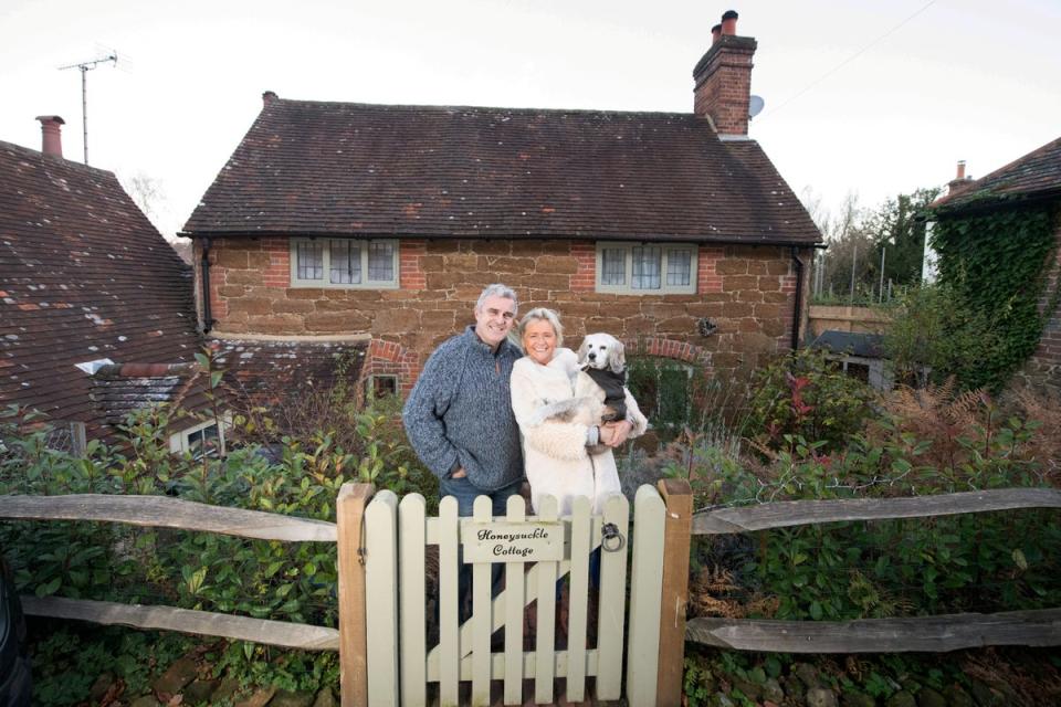 Jonny and Cressida outside their home with their dog, Jay (SWNS)