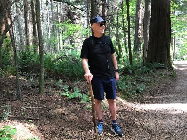 Bernie Steininger, 75, has walked in Stanley Park every day for 10 years. He now carries a stick, whistle, noisemaker and bear spray to chase off aggressive coyotes. (Chad Pawson/CBC News - image credit)