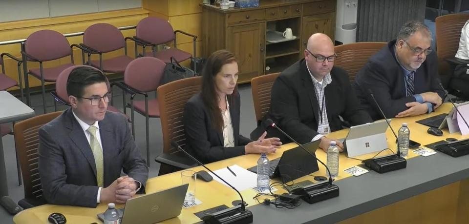 NTPC President and CEO Cory Strang (left) and Minister responsible for NTPC Caroline Wawzonek (centre) speak to members of the Legislative Assembly during a committee meeting on Monday. 