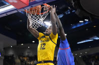 Marquette's Olivier-Maxence Prosper (12) dunks over DePaul's Yor Anei during the first half of an NCAA college basketball game, Saturday, Jan. 28, 2023, in Chicago. (AP Photo/Charles Rex Arbogast)