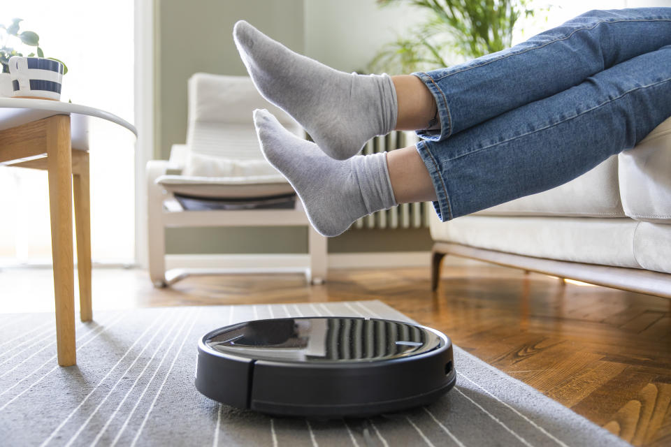 vacuum, Young woman lift up the feet for letting robotic vacuum cleaner pass though, iRobot Roomba Combo j5 Robot Vacuum & Mop – Identifies and Avoids Obstacles Like Pet Waste & Cords, Clean by Room with Smart Mapping, Works with Alexa, Ideal for Pet Hair