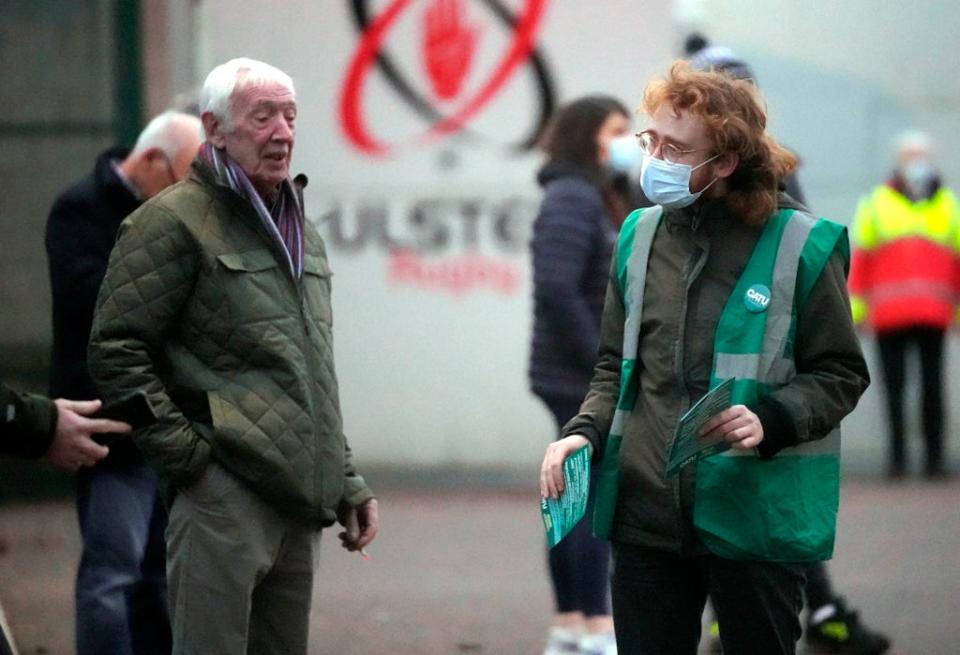 A campaigner speaks to a rugby fan outside the Kingspan Stadium (Niall Carson/PA)