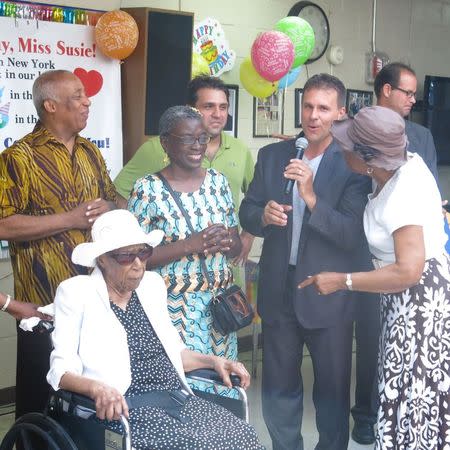 Susannah Mushatt Jones (2nd L) celebrates her 115th birthday at Vandalia Senior Center in New York in this July 8, 2014 handout photo obtained by Reuters July 6, 2015, alongside Executive Director Paul Curiale (2nd R), Councilwoman Inez Barron and former Councilman Charles Barron (L). Jones, whose birthday actually falls on July 6, is the world's oldest living woman at 116 years old. REUTERS/Millennium Development/Handout via Reuters