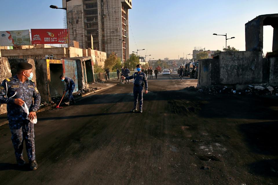 Security forces open anti-government protesters' site at the Joumhouriya Bridge that leads to the Green Zone government areas, in Baghdad, Iraq, Saturday, Oct. 31, 2020. (AP Photo/Khalid Mohammed)