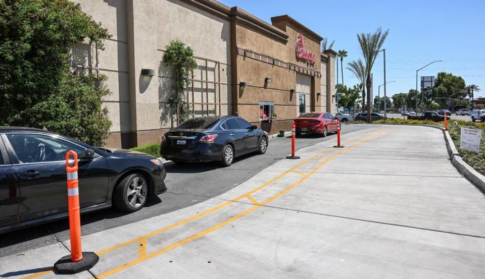 Cars pull up to the drive-thru window at Chick-fil-A’s River Park location at Blackstone and Nees avenues in Fresno on Monday, Aug. 7, 2023.