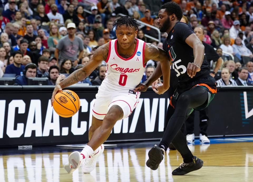 Mar 24, 2023; Kansas City, MO, USA; Houston Cougars guard Marcus Sasser (0) drives against Miami (Fl) Hurricanes guard Wooga Poplar (55) during the second half of an NCAA tournament Midwest Regional semifinal at T-Mobile Center.