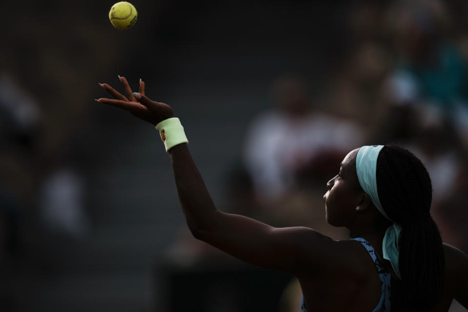 Coco Gauff of the U.S. serves against Canada's Rebecca Marino during their first round match at the French Open tennis tournament in Roland Garros stadium in Paris, France, Sunday, May 22, 2022. (AP Photo/Thibault Camus)