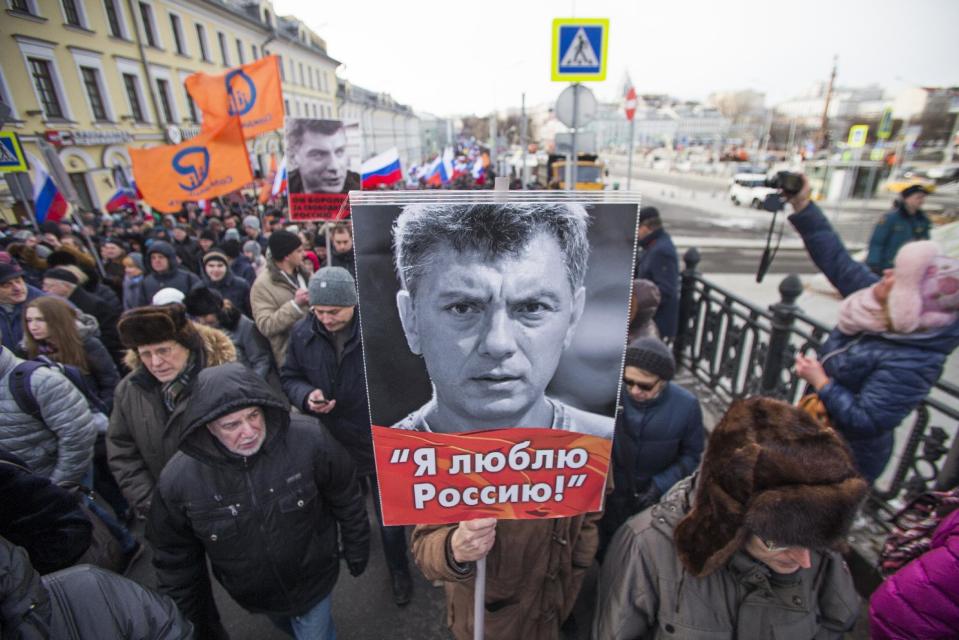 People march in memory of opposition leader Boris Nemtsov, portrait in center, in Moscow, Russia, Sunday, Feb. 26, 2017. Thousands of Russians take to the streets of downtown Moscow to mark two years since Nemtsov was gunned down outside the Kremlin. The poster reads: I love Russia. (AP Photo/Ivan Sekretarev)