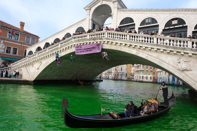 Waters of Grand Canal turned green after a protest by 'Extinction Rebellion' climate activists in Venice