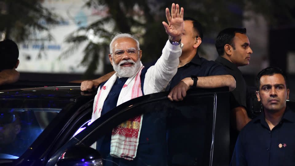 Indian prime minister and leader of the ruling Bharatiya Janata Party Narendra Modi waves to supporters at an election campaign event in Guwahati on April 16, 2024. - Biju Boro/AFP/Getty Images