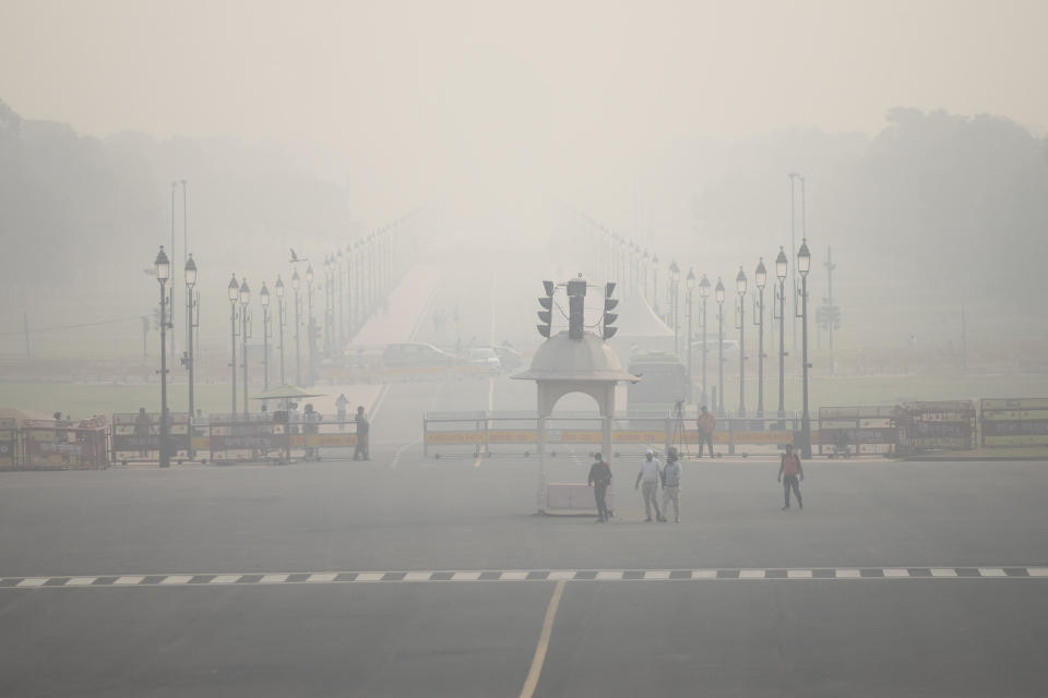 Commuters make their way past the presidential palace amid smoggy conditions in New Delhi, India, Nov. 7, 2023, with the Air Quality Index reading between 401 and 500 - considered 