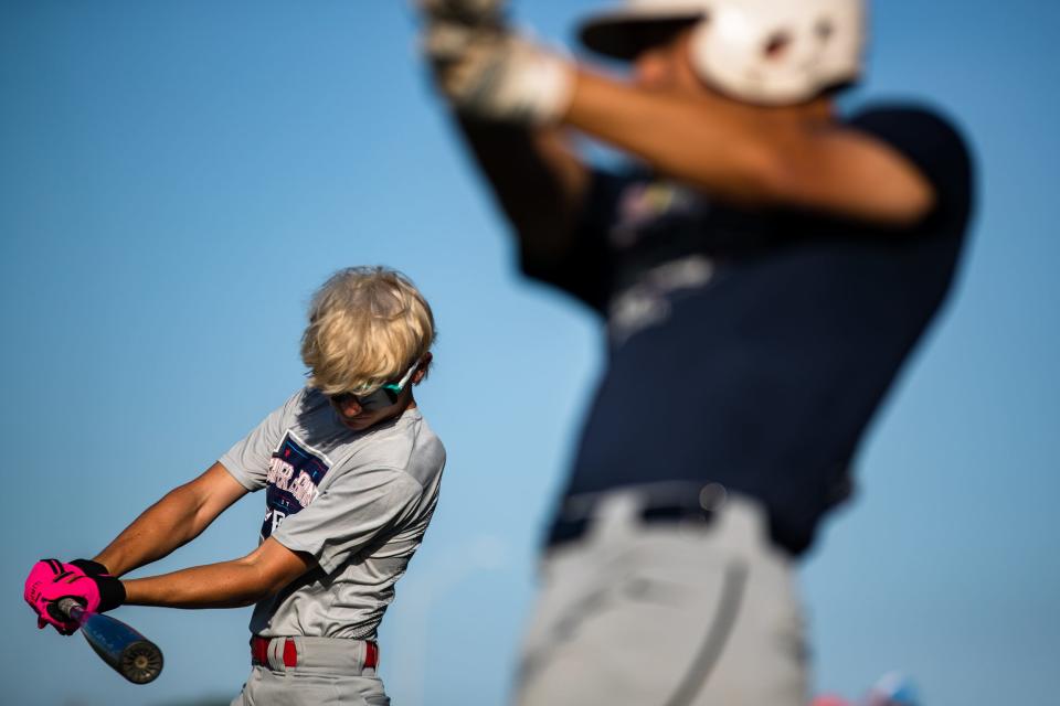 At left Drayton Mitchell, 14, takes a warmup swing at an Oil Belt Junior League team practice at Steve Castro Field in Robstown, Texas on Friday, July 29, 2022. The team has the potential to punch their ticket to the Junior League World Series at the Southwest Regional tournament in New Mexico this weekend.