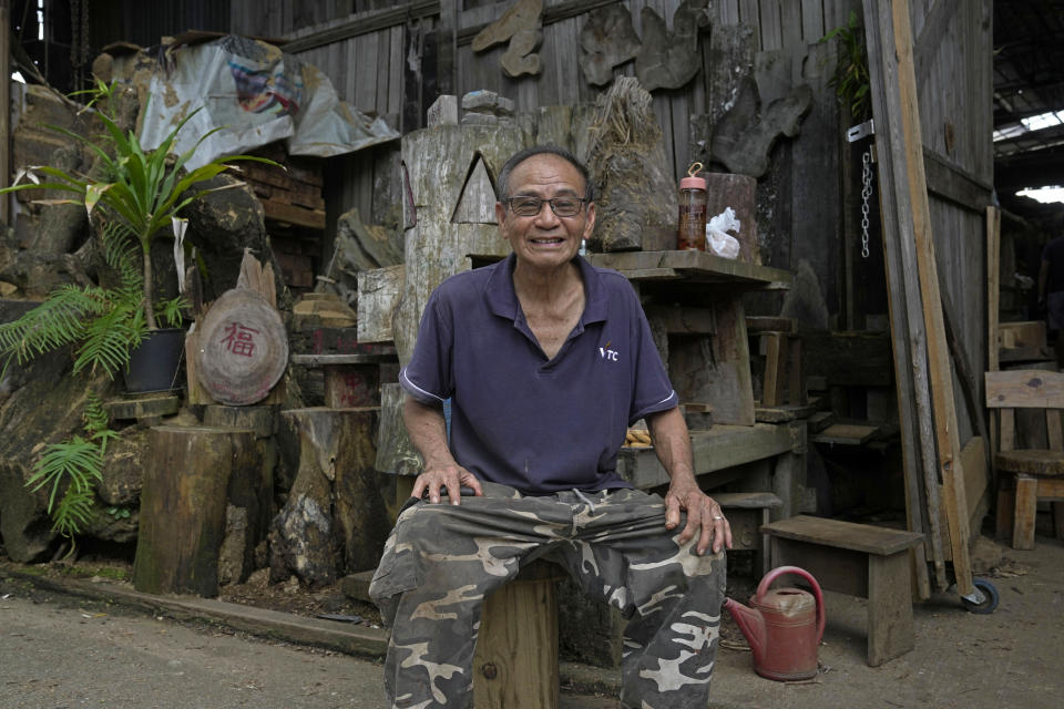 Wong Hung-kuen, Director of Chi Kee Sawmill & Timber, poses for a photograph in his factory in Hong Kong, Tuesday, July 12, 2022. Chi Kee Sawmill & Timber, Hong Kong's last operating sawmill, has operated in the city for nearly four decades. But soon, the sawmill could be forced to shut down as authorities look to develop the area to make it more metropolitan and integrate it better with mainland China. (AP Photo/Kin Cheung)