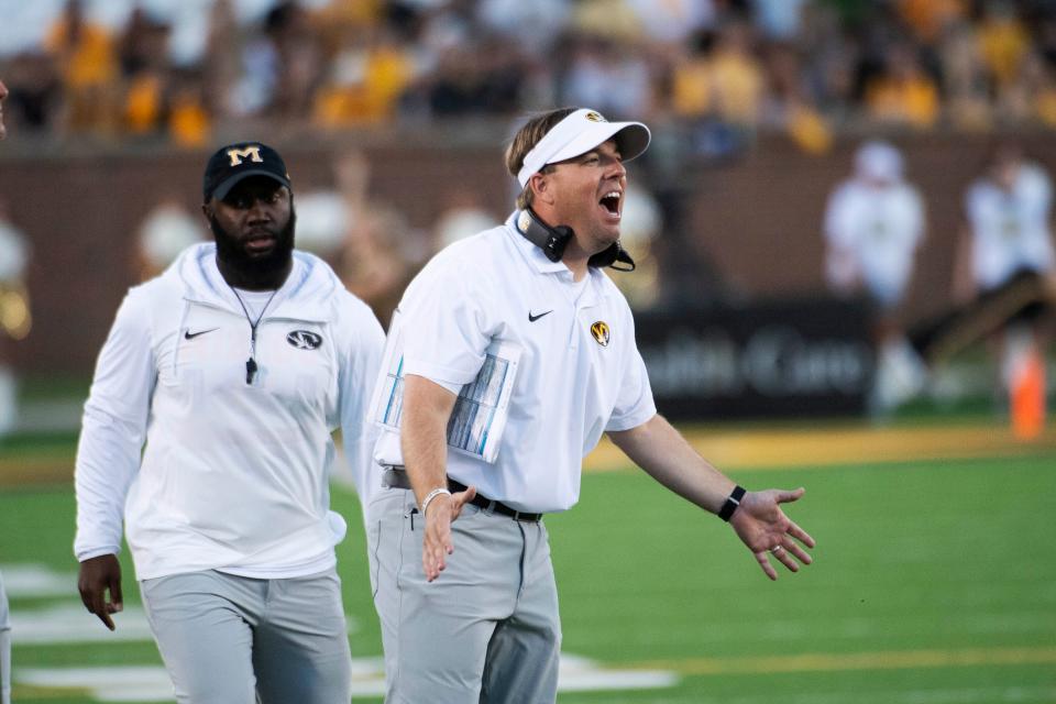 Missouri head coach Eliah Drinkwitz, right, argues a call during the first quarter of an NCAA college football game against South Dakota, Thursday, Aug. 31, 2023, in Columbia, Mo.