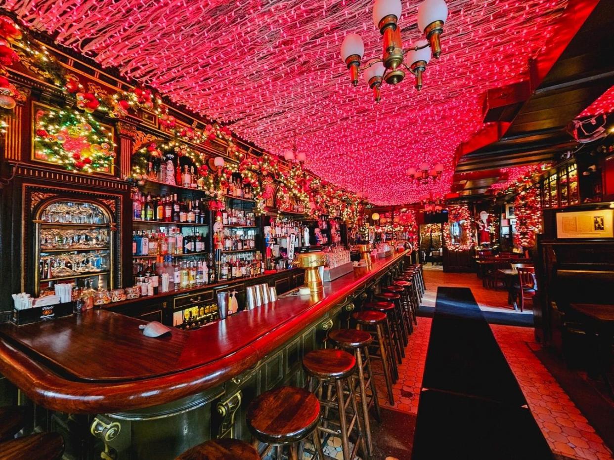 a bar with stools and tables