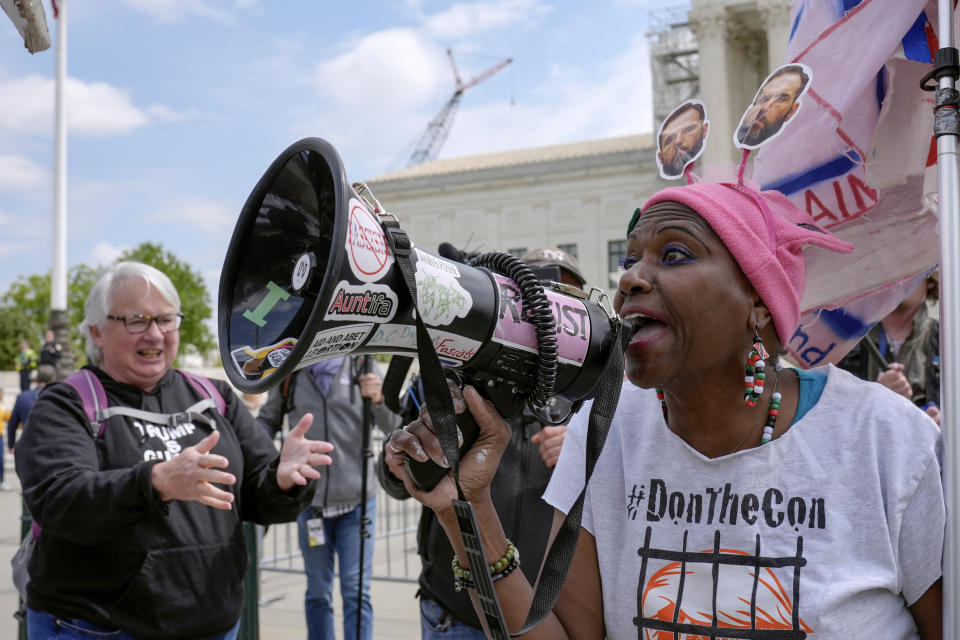 Demonstrators protest outside the Supreme Court as the justices prepare to hear arguments over whether Donald Trump is immune from prosecution in a case charging him with plotting to overturn the results of the 2020 presidential election, on Capitol Hill Thursday, April 25, 2024, in Washington. (AP Photo/Mariam Zuhaib)