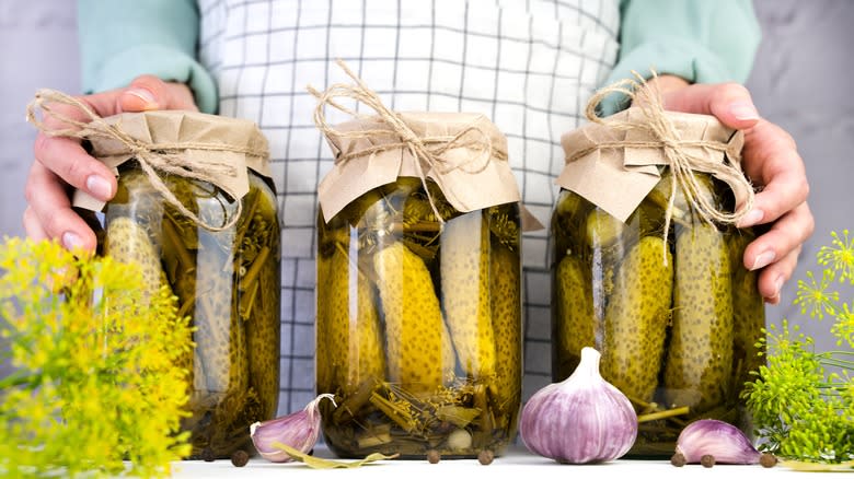 woman with homemade dill pickles