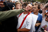 <p>A man wearing a shirt with swastikas on it is punched by an unidentified member of the crowd near the site of a planned speech by white nationalist Richard Spencer, who popularized the term ‘alt-right’, at the University of Florida campus on Oct.19, 2017 in Gainesville, Fla. (Photo: Brian Blanco/Getty Images) </p>