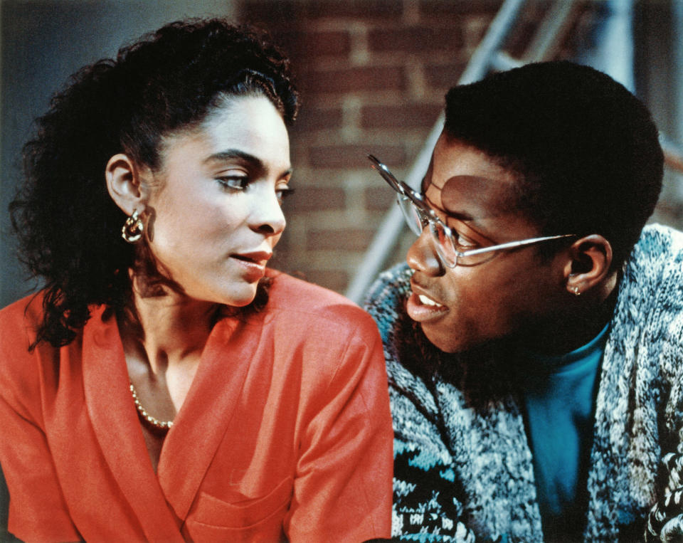 Two characters from "Coming to America" are engaged in conversation