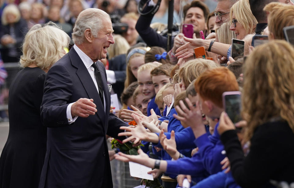 HILLSBOROUGH, NORTHERN IRELAND - SEPTEMBER 13: (EDITOR'S NOTE: Alternate crop) Crowds cheer as King Charles III and Camilla, Queen Consort arrive for a visit to Hillsborough Castle on September 13, 2022 in Hillsborough, United Kingdom. King Charles III is visiting Northern Ireland for the first time since ascending to the throne following the death of his mother, Queen Elizabeth II, who died at Balmoral Castle on September 8, 2022. (Photo by Niall Carson - WPA Pool/Getty Images)