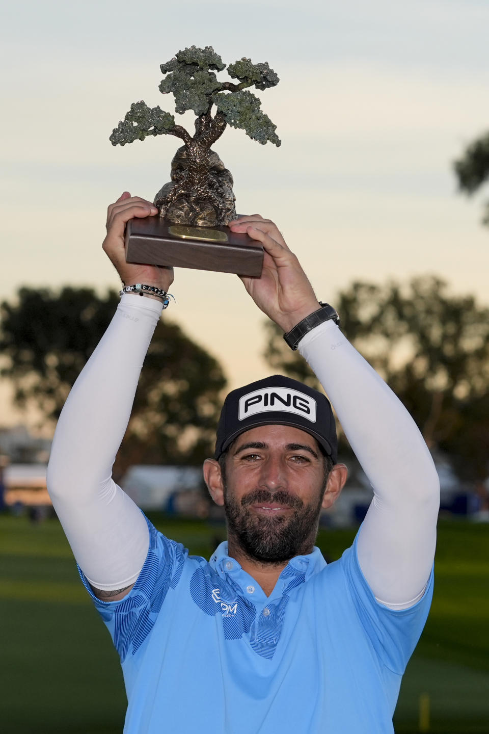 Matthieu Pavon holds the trophy after winning the Farmers Insurance Open golf tournament, Saturday, Jan. 27, 2024, in San Diego. (AP Photo/Gregory Bull)