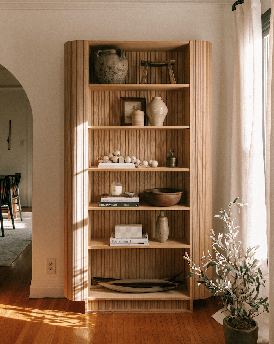 a shelf with vases and books