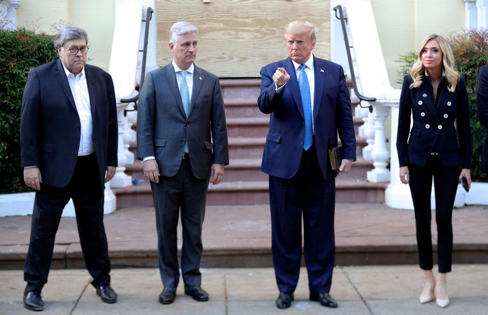 Donald Trump stands in front of St. John's Episcopal Church across from the White House with U.S. Attorney General Bill Barr, National Security Advisor Robert O'Brien and White House Press Secretary Kayleigh McEnany after walking there for a photo opportunity during ongoing protests over racial inequality in the wake of the death of George Floyd while in Minneapolis police custody, at the White House in Washington, U.S., June 1, 2020. (Tom Brenner/Reuters)