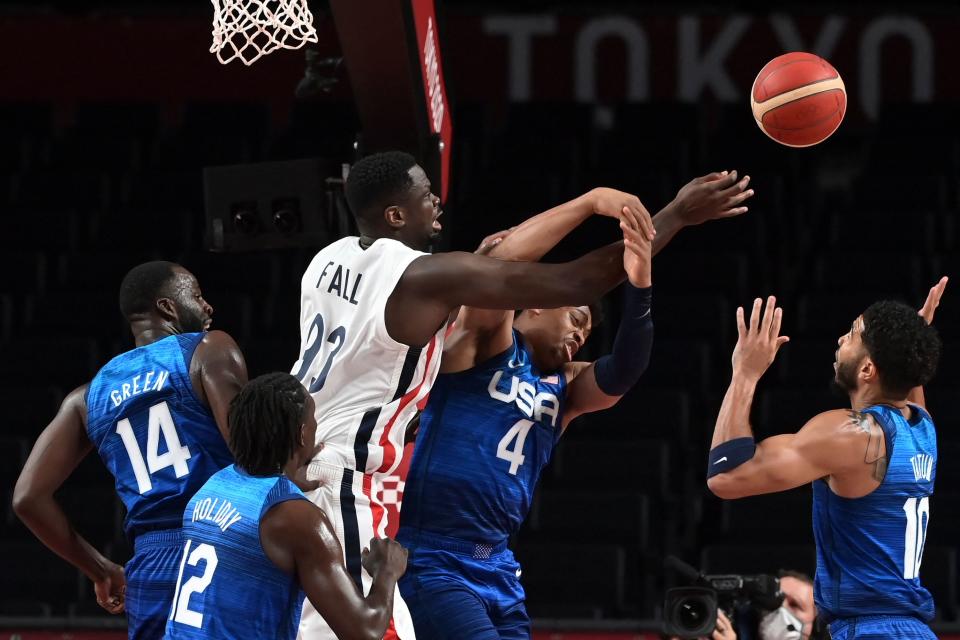 France's Moustapha Fall (3L) fights for the ball with USA's Keldon Johnson (2R) during the men's preliminary round group A basketball match between France and USA during the Tokyo 2020 Olympic Games at the Saitama Super Arena in Saitama on July 25, 2021. (Photo by Aris MESSINIS / AFP) (Photo by ARIS MESSINIS/AFP via Getty Images)