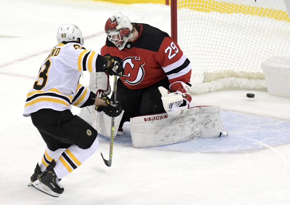 Boston Bruins center Brad Marchand (63) scores a goal past New Jersey Devils goaltender Makenzie Blackwood (29) during the shootout of an NHL hockey game Thursday, Jan. 14, 2021, in Newark, N.J. (AP Photo/Bill Kostroun)