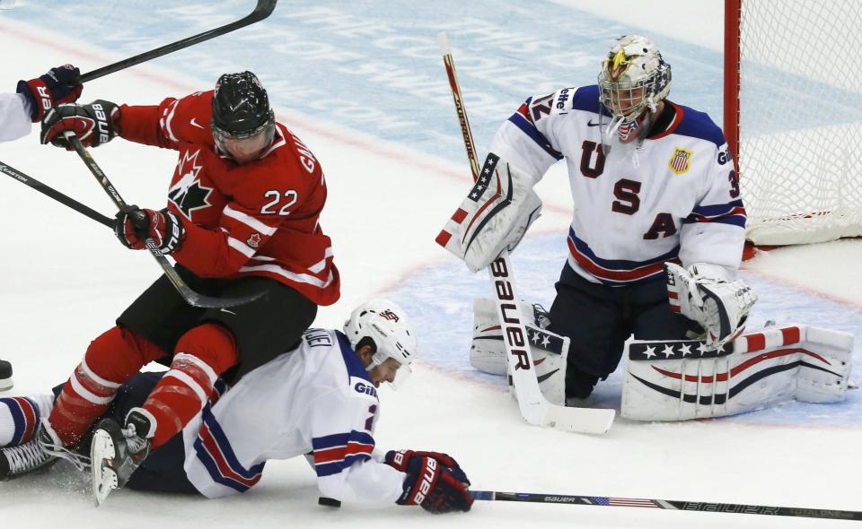 Canada's Gauthier falls on United States' Skjei during the first period of their IIHF World Junior Championship ice hockey game in Malmo