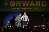 PARMA, OH - OCTOBER 18: Former U.S. President Bill Clinton (R) greets Bruce Springsteen on stage during the "Get Out The Vote" Event With Bill Clinton And Bruce Springsteen at Tri-C Western Campus Field House on October 18, 2012 in Parma, Ohio. (Photo by Duane Prokop/Getty Images)