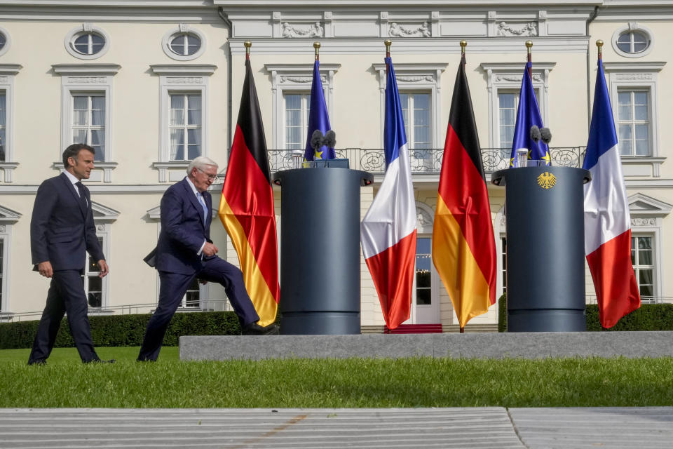 German President Frank-Walter Steinmeier, right, and French President Emmanuel Macron enter the podium for a press conference at Bellevue Place in Berlin, Germany, Sunday, May 26, 2024. (AP Photo/Markus Schreiber)